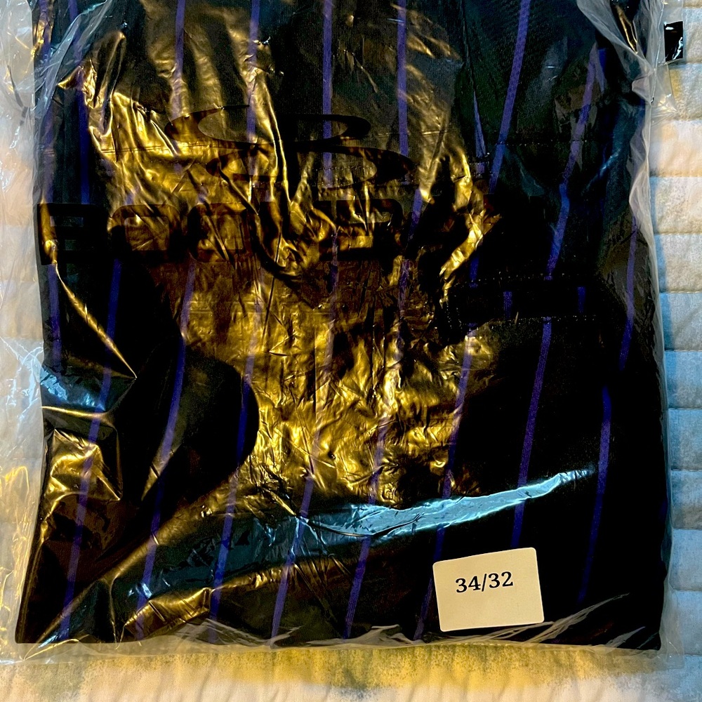 Brand new (still sealed in bag) Black and purple stripe baseball pants.